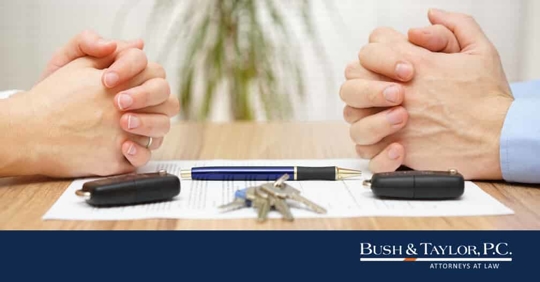 two crossed hands directly across from each other with paper and keys in between