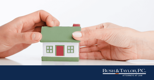 two hands fighting over small house