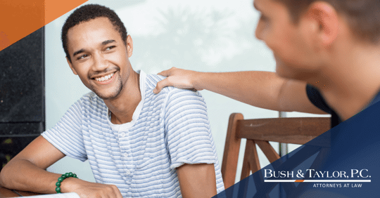 man putting hand supportingly on friends shoulder