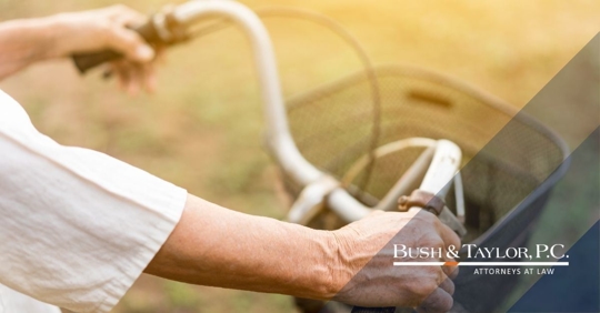 Older person riding a bike.