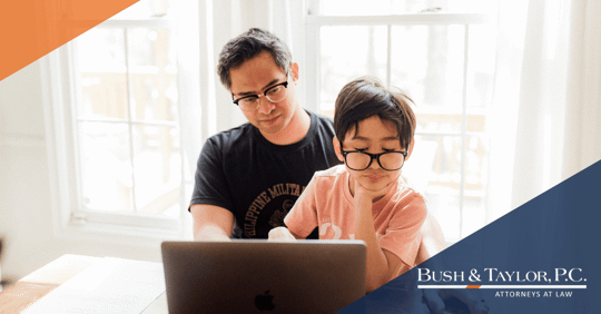 father and son looking at computer