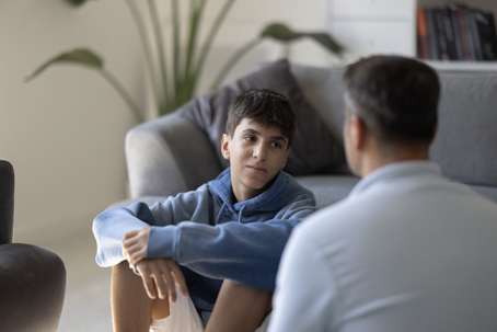 teen speaking with his parent