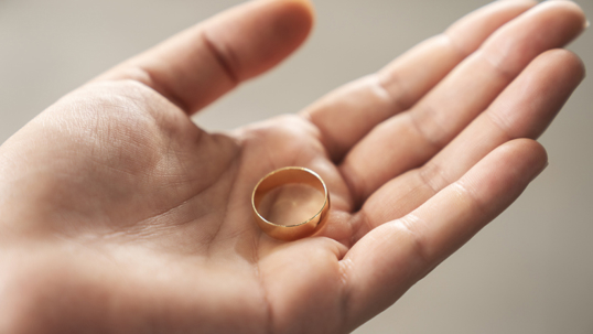 hand holding a wedding ring