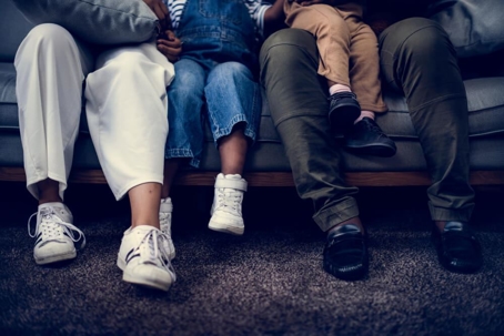 Closeup of family sitting on the couch.