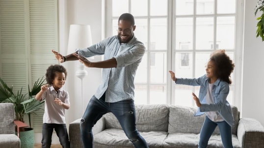 Dad with son and daughter engaged in funny activity