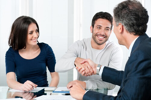 Couple signing prenuptial agreement